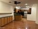 Kitchen with wood cabinets, granite countertops, and stainless steel appliances at 4200 N Miller Rd # 112, Scottsdale, AZ 85251