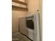 Laundry room with washer, dryer, and overhead shelving at 4200 N Miller Rd # 112, Scottsdale, AZ 85251