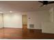 Living room with hardwood floors and access to another room at 4200 N Miller Rd # 112, Scottsdale, AZ 85251