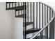 Close-up view of a sleek, black metal spiral staircase at 4220 N 32Nd St # 32, Phoenix, AZ 85018