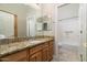 Bathroom with granite countertop, wood cabinets, and a tub at 4332 S Primrose Dr, Gold Canyon, AZ 85118