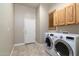 Laundry room with washer, dryer, and wood cabinets at 4332 S Primrose Dr, Gold Canyon, AZ 85118