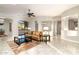 Sunlit living room with a leather sofa and views of the backyard at 4332 S Primrose Dr, Gold Canyon, AZ 85118