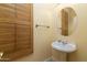 Elegant powder room with pedestal sink and wood shutters at 4332 S Primrose Dr, Gold Canyon, AZ 85118