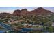 Aerial view of community near Camelback Mountain, showing homes, landscaping, and tennis courts at 4450 E Camelback Rd # 4, Phoenix, AZ 85018