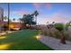 Landscaped backyard with artificial turf and lighting at 4450 E Camelback Rd # 4, Phoenix, AZ 85018