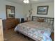 Main bedroom with a large bed, dresser, and a large window with arched top at 5110 E Edgewood Ave, Mesa, AZ 85206