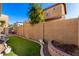 Landscaped backyard with artificial turf and a stone retaining wall at 5331 E Holmes Ave, Mesa, AZ 85206