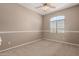 Bright bedroom with carpeted floor, ceiling fan, and window with blinds at 5331 E Holmes Ave, Mesa, AZ 85206