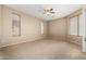 Bright bedroom with carpeted floors, ceiling fan, and window blinds at 5331 E Holmes Ave, Mesa, AZ 85206