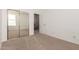 Bedroom with mirrored closet doors and access to upper level at 5331 E Holmes Ave, Mesa, AZ 85206