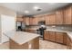 Spacious kitchen with light wood cabinets, stainless steel appliances, and an island at 5331 E Holmes Ave, Mesa, AZ 85206