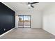 Spacious bedroom with wood-look floors and private balcony access at 5345 E Van Buren St # 226, Phoenix, AZ 85008