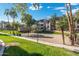 Community with grassy areas, volleyball court, and trees at 5345 E Van Buren St # 226, Phoenix, AZ 85008