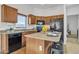 Modern kitchen with wood cabinets, a large island, and stainless steel appliances at 544 N Alma School Rd # 9, Mesa, AZ 85201