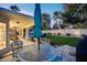 Outdoor dining area with a glass table and a view of the pool and landscaped yard at 6320 E Kings Ave, Scottsdale, AZ 85254