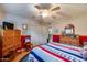 A bedroom featuring red, white, and blue decor, wooden floors and a ceiling fan at 6320 E Kings Ave, Scottsdale, AZ 85254