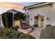 Beautiful home exterior featuring lush landscaping, mature palm trees, and a tiled front porch at 6320 E Kings Ave, Scottsdale, AZ 85254