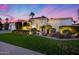 Beautiful home exterior featuring manicured lawn, decorative shrubs, and a tile roof at 6320 E Kings Ave, Scottsdale, AZ 85254