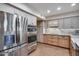 Modern kitchen with stainless steel refrigerator, double oven, and sleek countertops at 6320 E Kings Ave, Scottsdale, AZ 85254