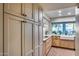 Bright kitchen features shaker cabinets, stainless appliances, and a farmhouse sink with a view at 6320 E Kings Ave, Scottsdale, AZ 85254