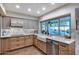 Bright kitchen area with modern appliances, a farmhouse sink, and a view of the pool at 6320 E Kings Ave, Scottsdale, AZ 85254