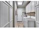 Well-lit laundry room with white cabinets, washer and dryer, and a skylight at 6320 E Kings Ave, Scottsdale, AZ 85254