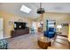 Cozy living room with vaulted ceilings, skylight, tile floors, and a stylish ceiling fan at 6320 E Kings Ave, Scottsdale, AZ 85254