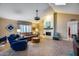 Living room features a brick fireplace, skylight, and tile flooring, with a large window for natural light at 6320 E Kings Ave, Scottsdale, AZ 85254