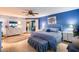 Main bedroom with a blue accent wall, ceiling fan, and light wood flooring at 6320 E Kings Ave, Scottsdale, AZ 85254