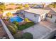 Aerial view of the backyard featuring a concrete patio, pool and spa, and mature landscaping at 6838 E Almeria Rd, Scottsdale, AZ 85257