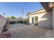 Exterior shot of the backyard featuring a large concrete patio and mature landscaping at 6838 E Almeria Rd, Scottsdale, AZ 85257