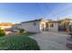 Backyard view of the home showing mature landscaping, a concrete patio, and an inground pool at 6838 E Almeria Rd, Scottsdale, AZ 85257