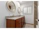 Bathroom featuring a double sink vanity with granite countertop and wood cabinets at 6838 E Almeria Rd, Scottsdale, AZ 85257