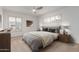 Bright bedroom with neutral color scheme, ceiling fan and ample natural light from shuttered windows at 6838 E Almeria Rd, Scottsdale, AZ 85257