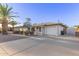 Beautiful single-story home with a long driveway and well-manicured landscaping at 6838 E Almeria Rd, Scottsdale, AZ 85257