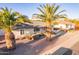 Attractive single-story home featuring lush landscaping and mature palm trees at 6838 E Almeria Rd, Scottsdale, AZ 85257