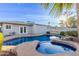 Backyard pool features a built-in spa, stone accents, and a view of the home's exterior at 6838 E Almeria Rd, Scottsdale, AZ 85257