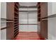 Spacious walk-in closet with custom shelving and drawers for maximum organization at 6838 E Almeria Rd, Scottsdale, AZ 85257