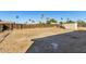 Empty lot backyard with a shed and wooden fence at 7030 W Cypress St, Phoenix, AZ 85035