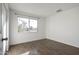 Bedroom with large window and wood-look tile floors at 7030 W Cypress St, Phoenix, AZ 85035