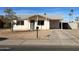 Charming single-story home with a well-kept front yard and covered parking at 7030 W Cypress St, Phoenix, AZ 85035
