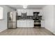 Modern kitchen with stainless steel appliances and backsplash at 7030 W Cypress St, Phoenix, AZ 85035