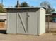 Gray storage shed with a single door at 7030 W Cypress St, Phoenix, AZ 85035