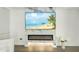 Modern electric fireplace with marble surround and large TV above at 7161 E Rancho Vista Dr # 3002, Scottsdale, AZ 85251