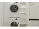 Stackable washer and dryer in a well-lit laundry room with storage at 7161 E Rancho Vista Dr # 3002, Scottsdale, AZ 85251