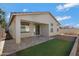 Covered patio, grassy area, and gravel landscaping in the backyard at 7206 W Wood St, Phoenix, AZ 85043