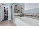 Bathroom with soaking tub, shower, and walk-in closet at 7206 W Wood St, Phoenix, AZ 85043