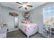 Charming bedroom with floral bedding and built-in shelving at 7206 W Wood St, Phoenix, AZ 85043