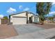 Single-story home with a two-car garage and desert landscaping at 7206 W Wood St, Phoenix, AZ 85043